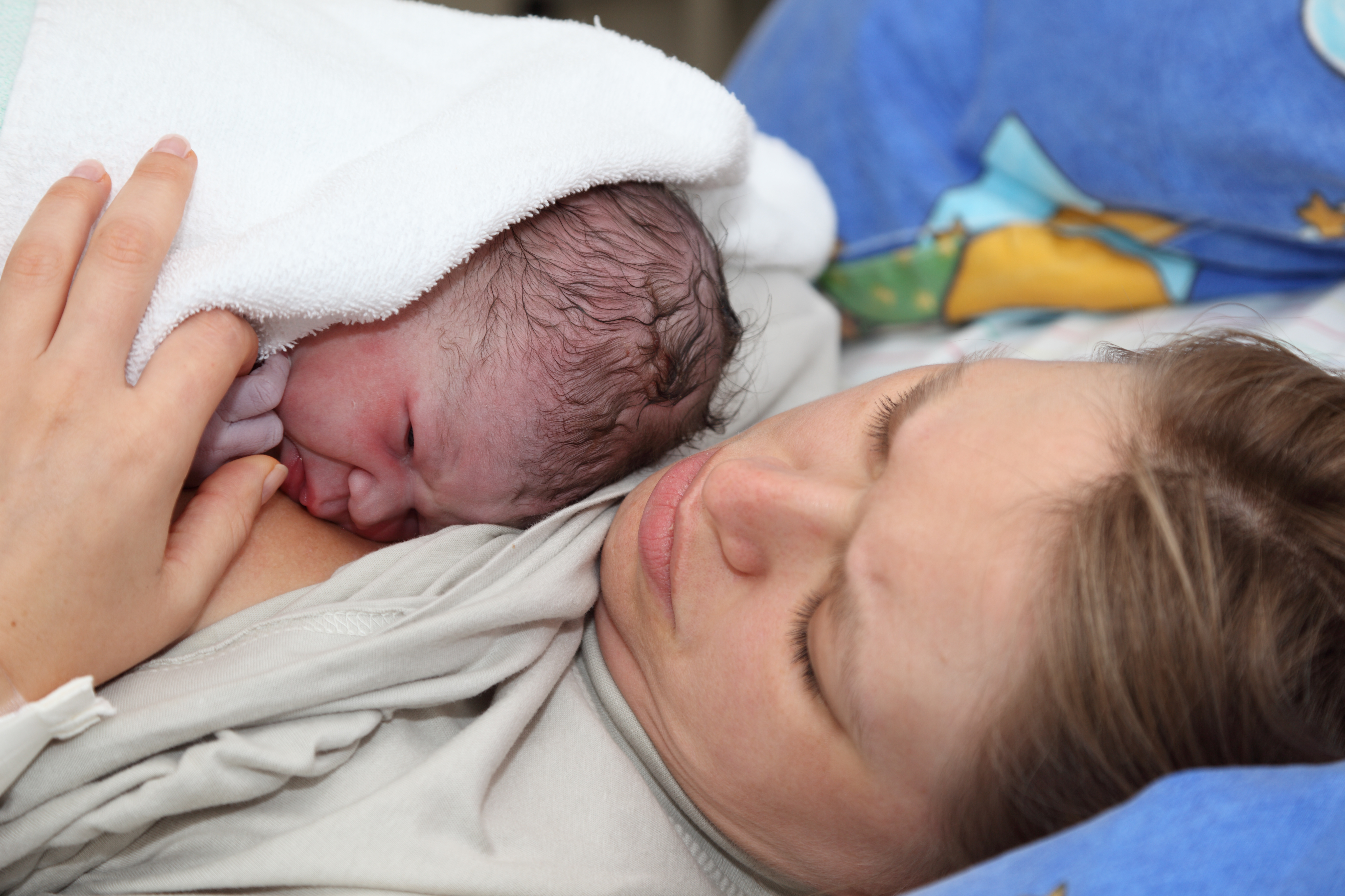 Newborn baby with mother minutes after the birth